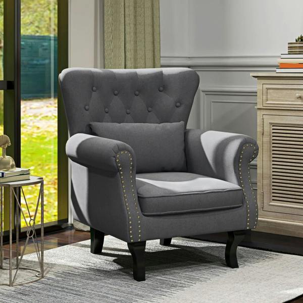 Dark grey Chesterfield-style accent chair with tufted back and studded rolled arms