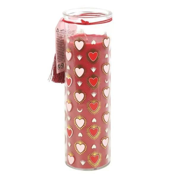 Printed tube candle with pink heart pattern and red tassel, side view