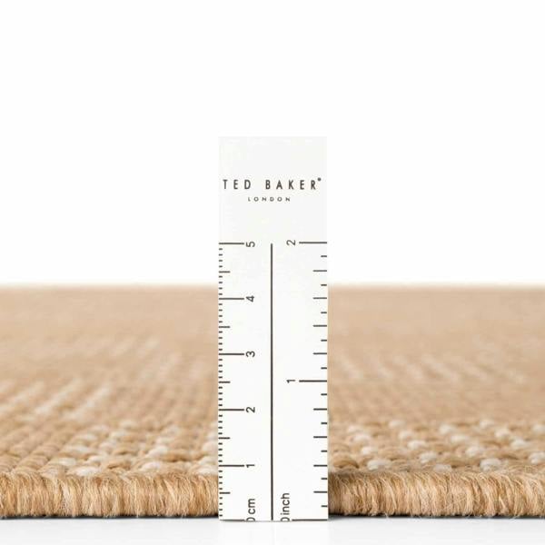Close-up of a textured surface with a ruler and 'Ted Baker' branding.