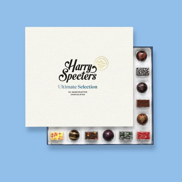 A box of 36 artisan chocolates by Harry Specters partially covered by a box lid 