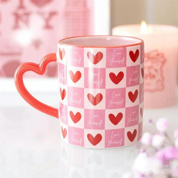 Pink checkered heart mug with red heart pattern and red heart-shaped handle