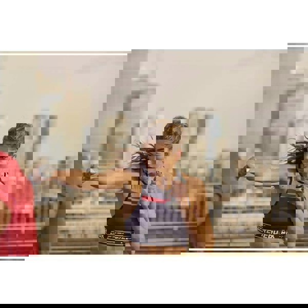 Woman exercising outside with Reebok 1kg Dumbbells