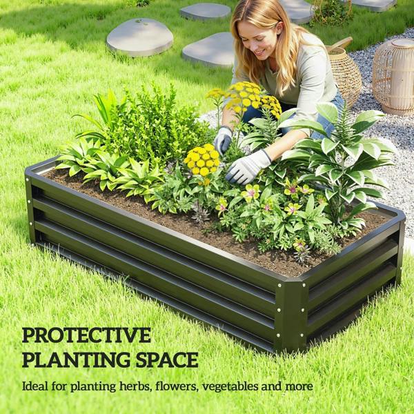 Raised garden planter bed with slatted sides, filled with seedlings on patio grass