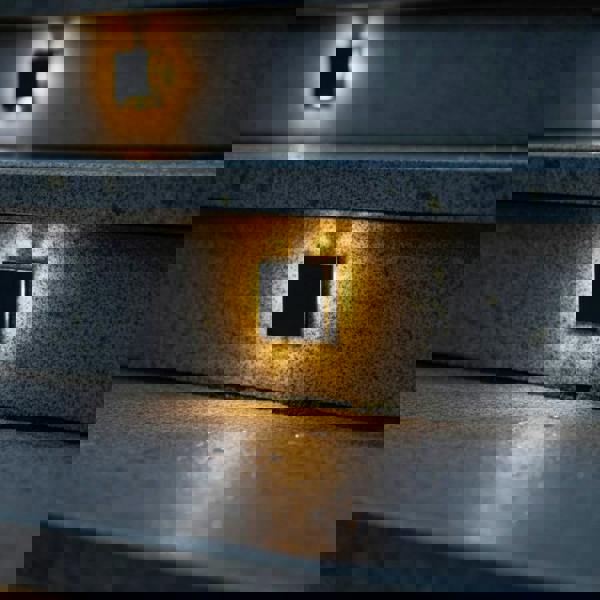 black outdoor step light mounted in the stair riser of concrete outdoor steps