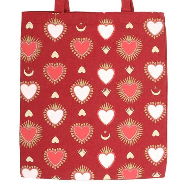Red square tote bag with hearts, moons, and sunburst icon pattern