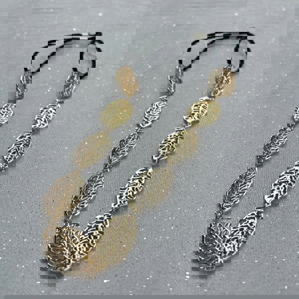 Leaf headband, gold tone metal leaves with intricate cutout detailing, linked design, black elastic fastening for secure fit, nature inspired accessory, elegant vintage style headpiece, chic statement hairband, stylish gift for her
