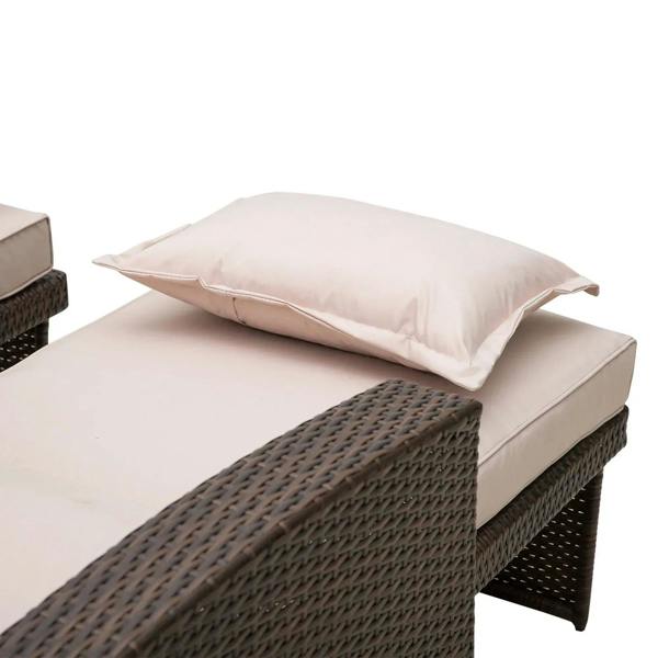 Brown rattan sofa lounger with beige seat pad and pillow for reclining comfort