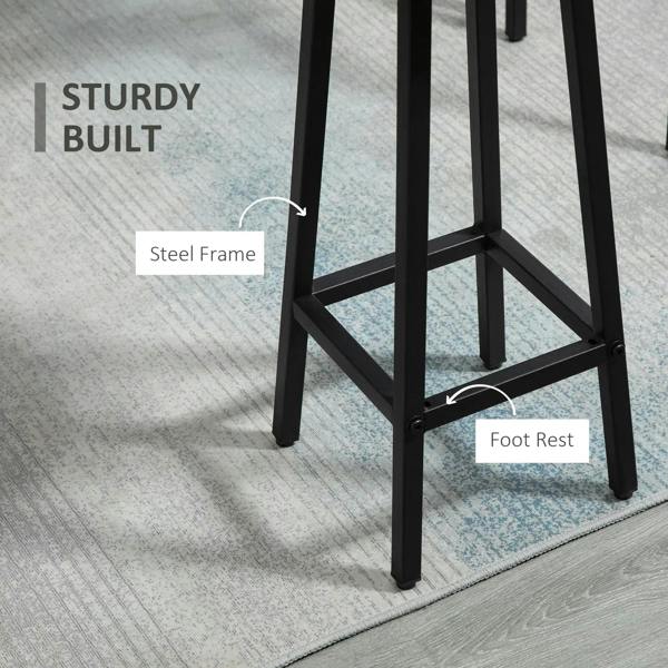 Close-up of black steel stool frame with angled legs and circular footrest