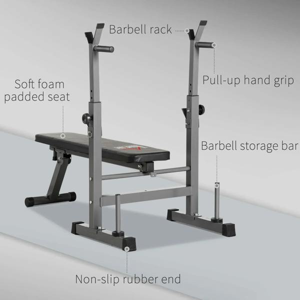 Barbell rack and black padded workout bench with pull-up grips and storage bar