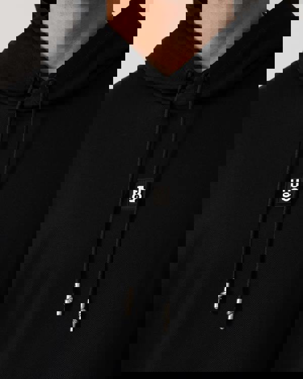 Model wearing HUGO Mens Dineo Mens Pullover Hoodie in Black 001 - Logo detail