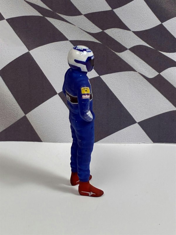 a toy figure in a blue suit