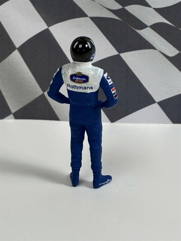 a toy figure of a race car driver
