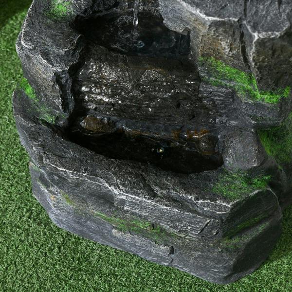 Dark grey rock water fountain basin with green moss and water channels