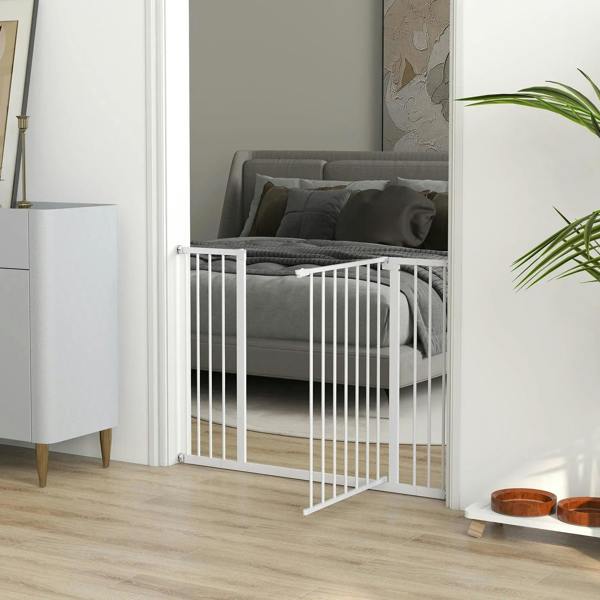 White pet safety gate with vertical bars installed near a sofa