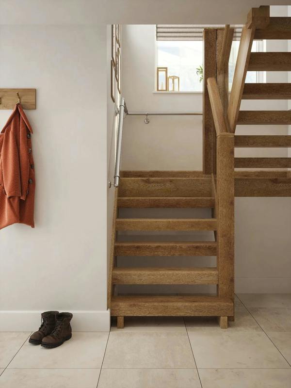 Brushed silver 40mm half turn handrail installed along hallway staircase wall, front view