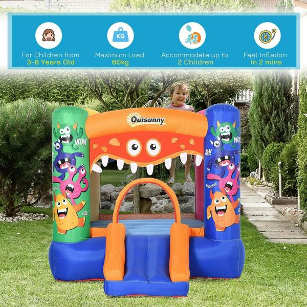 Monster inflatable bounce castle in yard, blue base with orange slide and mesh basket