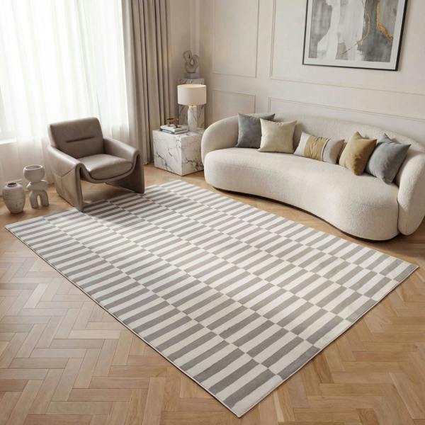 Living room with a patterned rug, sofa, and armchair.