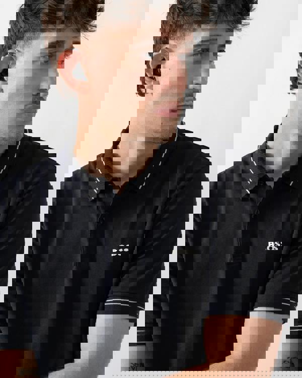 close up shot of a model wearing a BOSS Green PL_Member Mens Short Sleeve Polo Shirt in Dark Blue 402