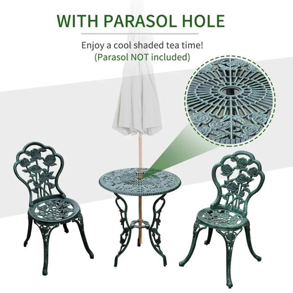 Antique green cast aluminum bistro table with parasol hole and two matching floral chairs.