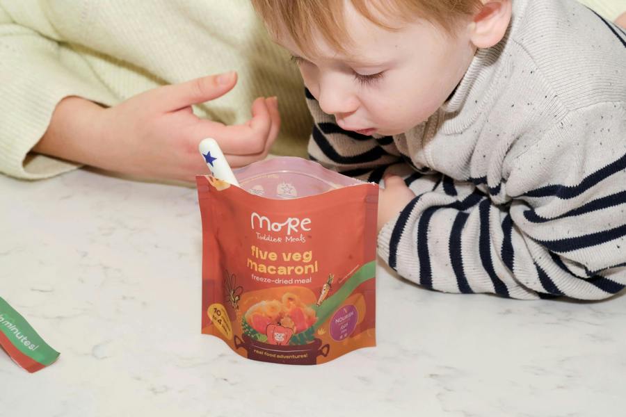 Mum and toddler looking at a prepared more toddler meal for dinner time healthy meal. 