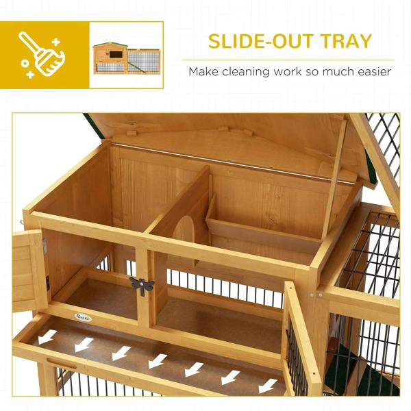 Wooden rabbit hutch interior with slide-out tray and divided compartments behind wire mesh