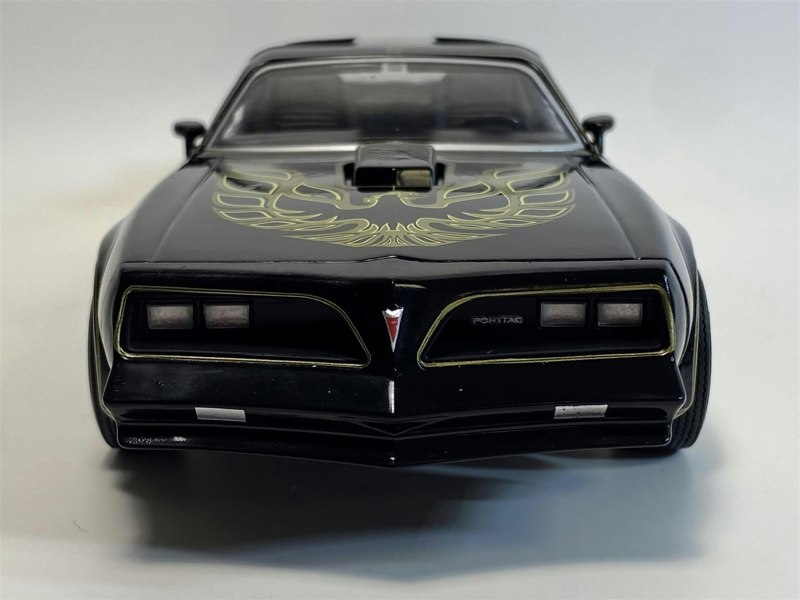 a black toy car with a gold design on it