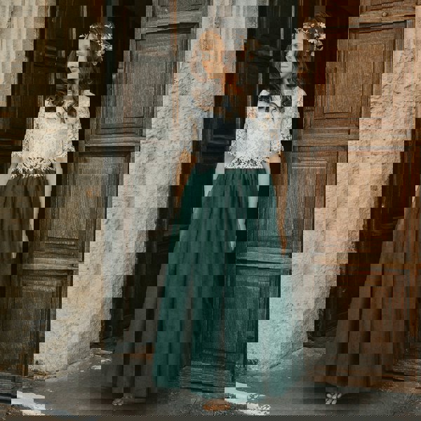 bridesmaid wearing hunter green skirt and lace top