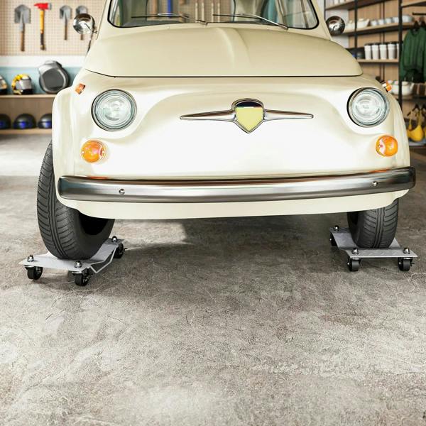 Car supported on two-piece metal wheel dollies with swivel casters under tires.