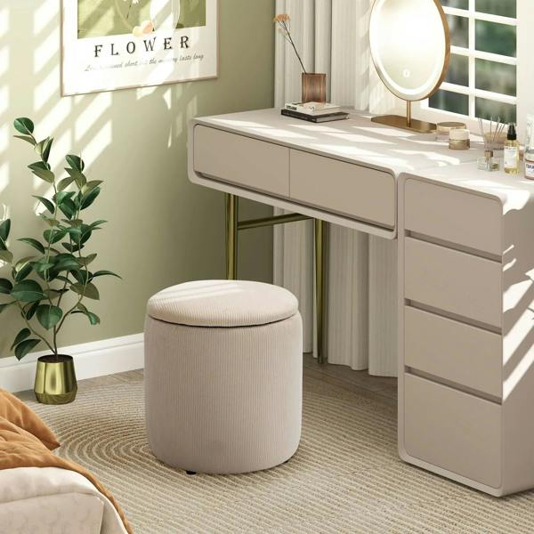 Cream white round ottoman with removable lid and storage, in front of vanity console.