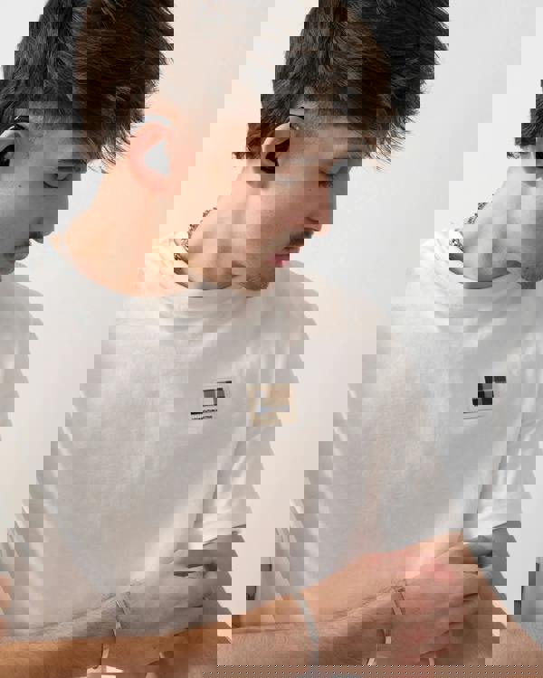 close up shot of a model wearing an Aquascutum Mens Badge T-Shirt in Old White