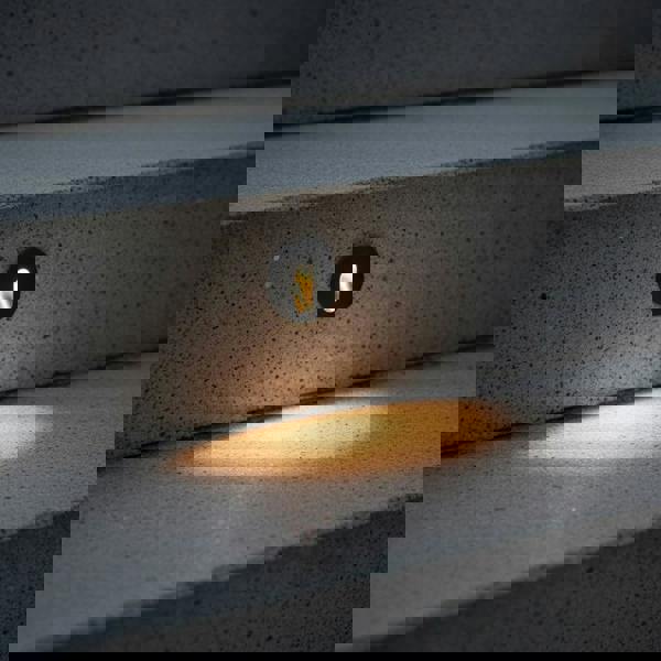 black outdoor stair step light mounted into concrete steps outside 