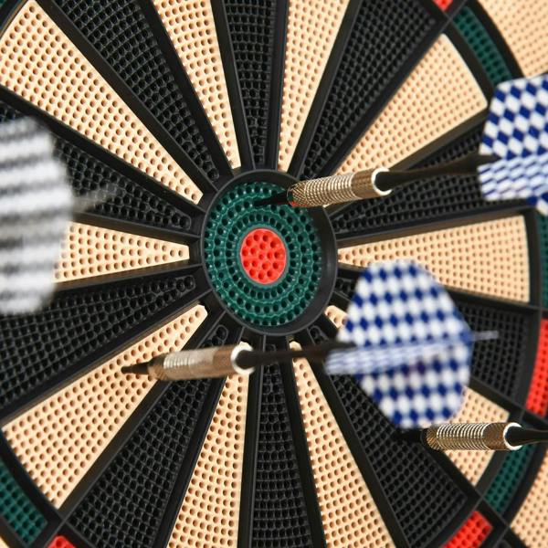 Bullseye close-up on electronic dartboard with darts, green center ring and red inner target