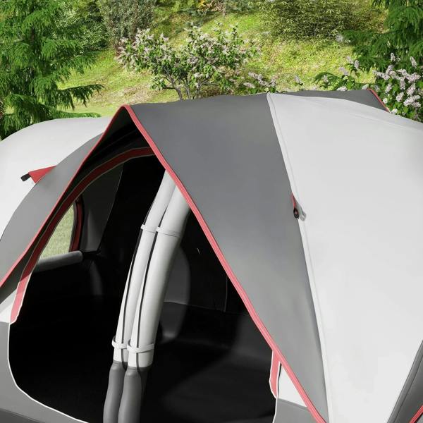 Grey camping tent close-up with red-trim entrance arch and interior poles