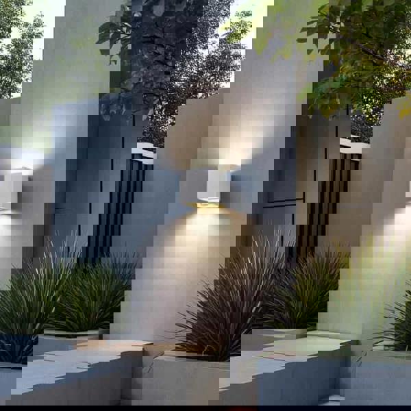 white up and down outside light mounted on a white wall outside a modern house 