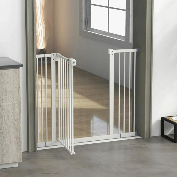 White adjustable safety gate at a doorway with hinged door and vertical bars
