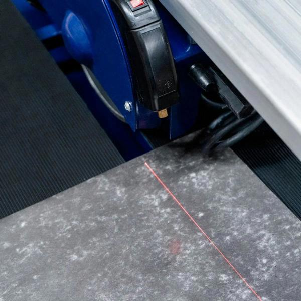 Wet tile cutter bench with a 720mm cutting surface, featuring a precise laser guide and durable black rubber mat for stability