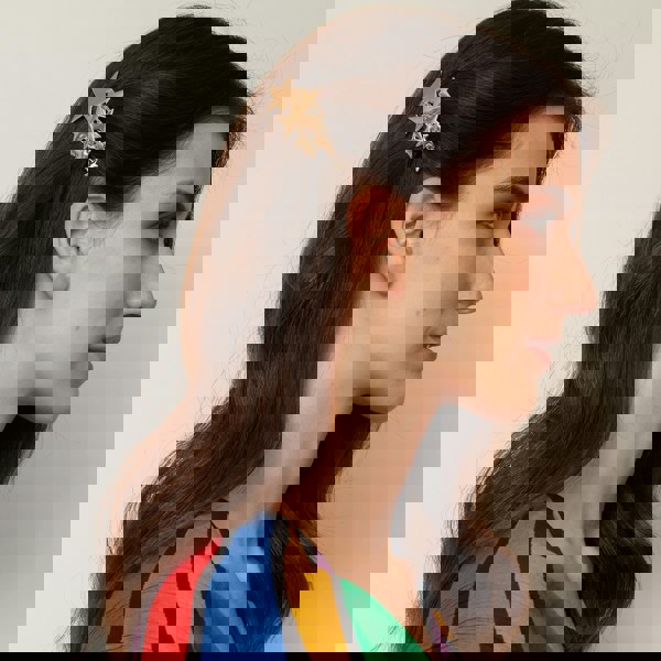 star hair clip in gold styled for festival hair