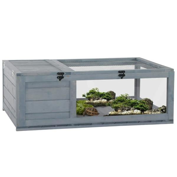 Grey small wooden reptile house with mesh roof, front opening, and interior plants