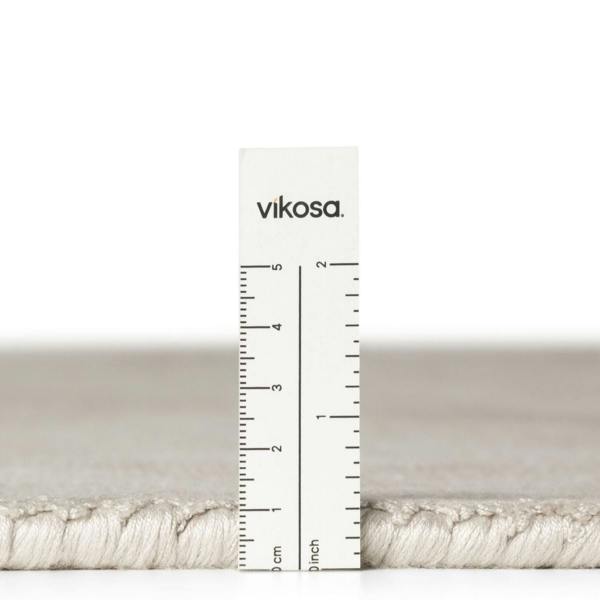 Vikosa yarn with a ruler for measurement on a white background