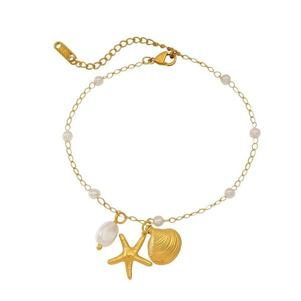 Gold anklet with starfish, shell, and pearl charm on a white background