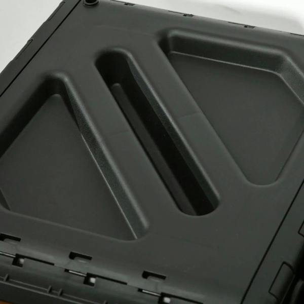 Black composter lid detail with molded ridges and recessed handle opening