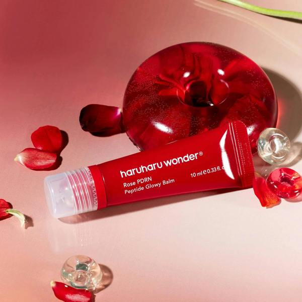 Smooth, solid, and buttery-soft clear pink glaze texture of Haruharu Wonder Rose PDRN Balm gliding effortlessly over skin contours at Atelier De Glow UK.