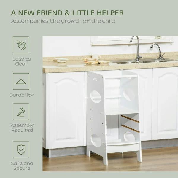White toddler step stool tower with safety rail beside kitchen counter, child using it