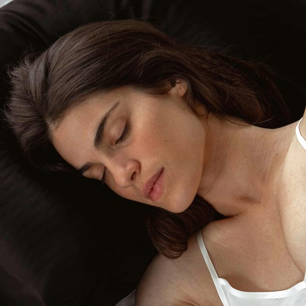 Female model sleeping on black Drowsy silk pillowcase