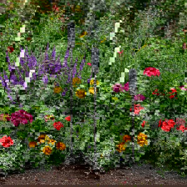 black garden spike light IP65 mounted at different heights in a garden border