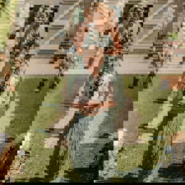 Young flower girl followed by bridesmaids