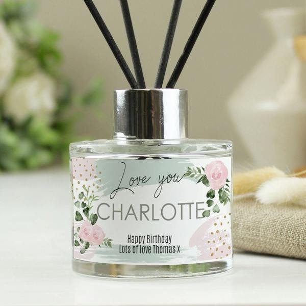 Custom name reed diffuser for Charlotte with a birthday message and silver collar.