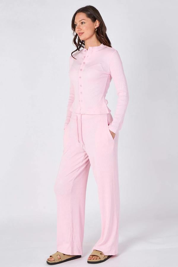 Woman wearing a pink outfit on a white background
