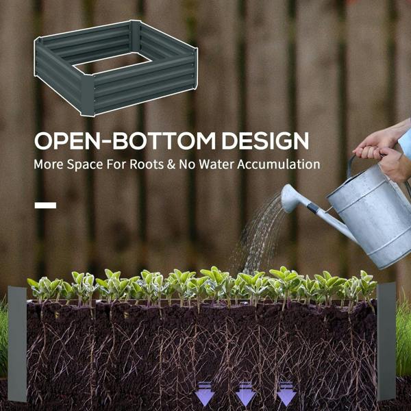 Dark grey raised garden bed planter with seedlings being watered