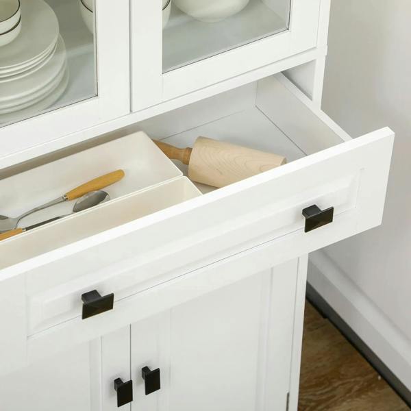 Close-up of white cabinet drawer with black handle and door hinges below